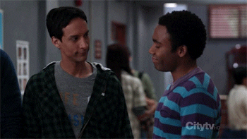 Gif of 'secret' high-five handshake between characters Abed and Troy from the series Community
